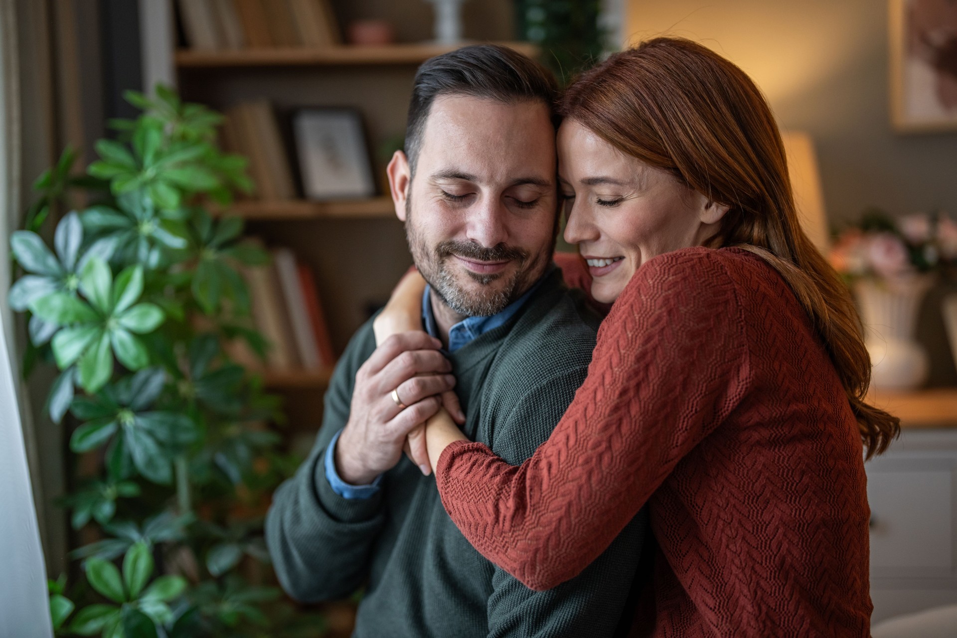 Romantic embrace between a couple in their living room