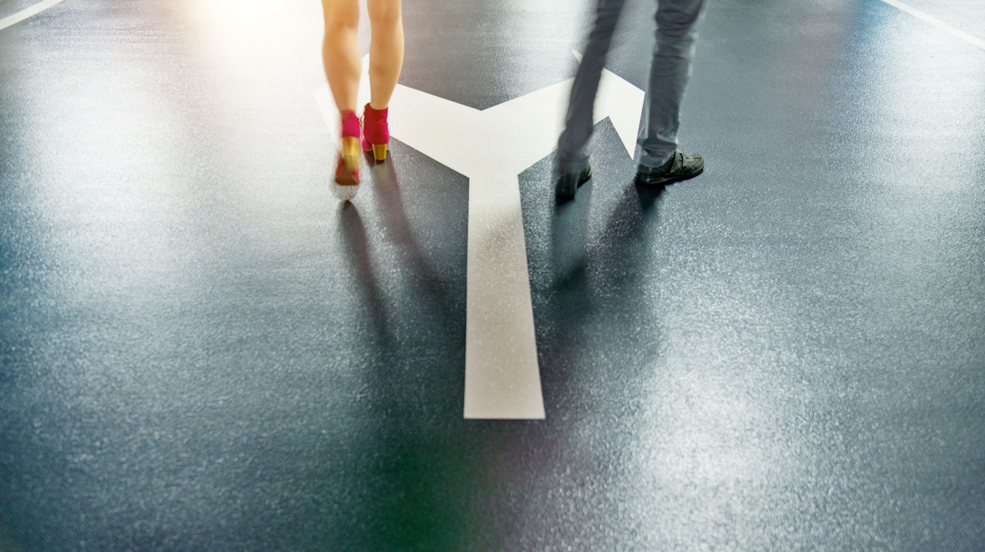 Man and woman walking on forked road